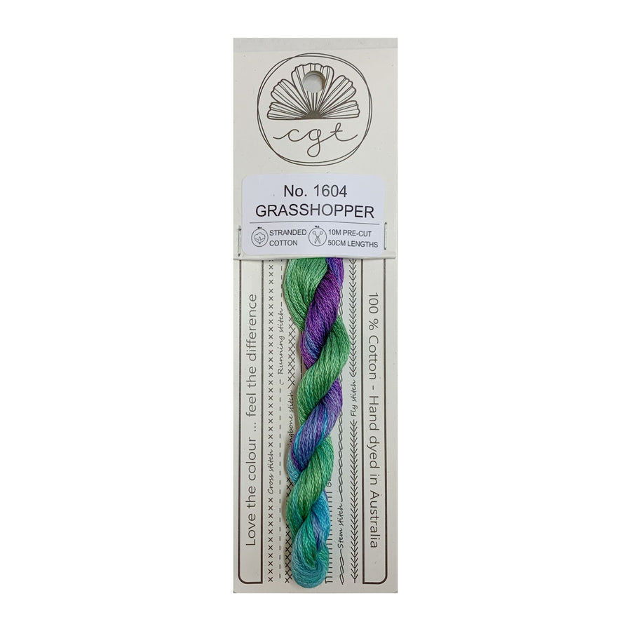 A skein of hand-dyed multicolor embroidery floss labeled 'Grasshopper' from Cottage Garden Threads on a cardboard retail packaging.