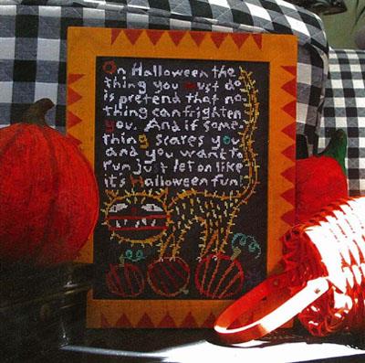 Halloween-themed framed text with pumpkins and a checkered background