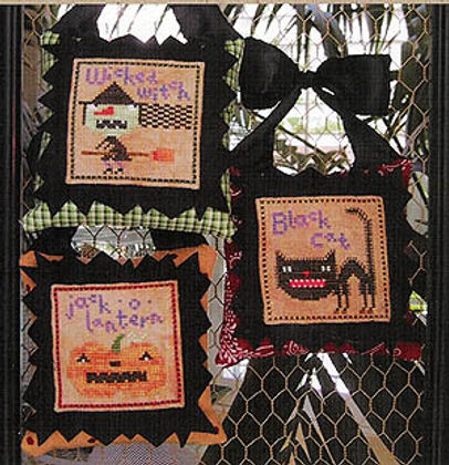 Decorative Halloween-themed wall hanging with embroidered designs on a black background.
