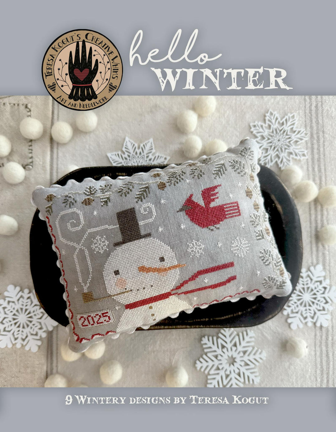 Cross-stitched snowman design on a book cover with 'hello WINTER' text and Teresa Kogut's branding.