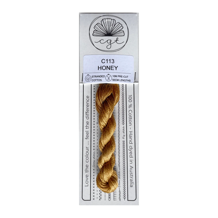  skein of honey-colored thread with packaging on a white background