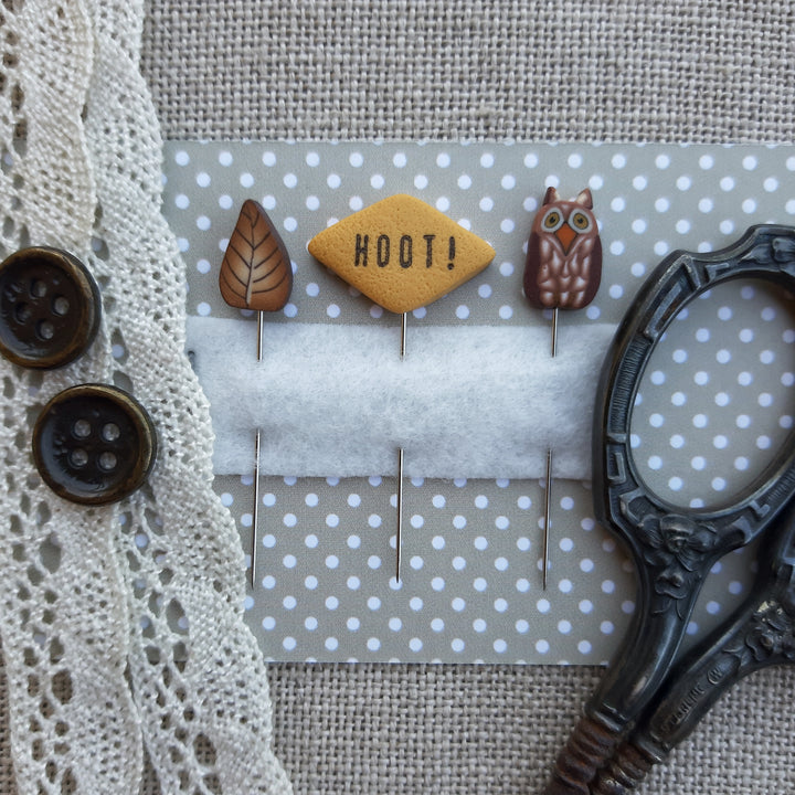 set of three handmade pins include autumn leaf, owl, and diamond shape reading hoot 