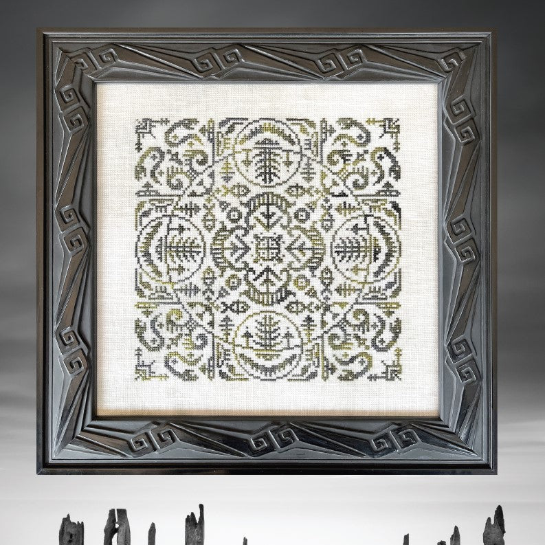 Decorative framed artwork with a geometric pattern and wooden sticks on a gray background.