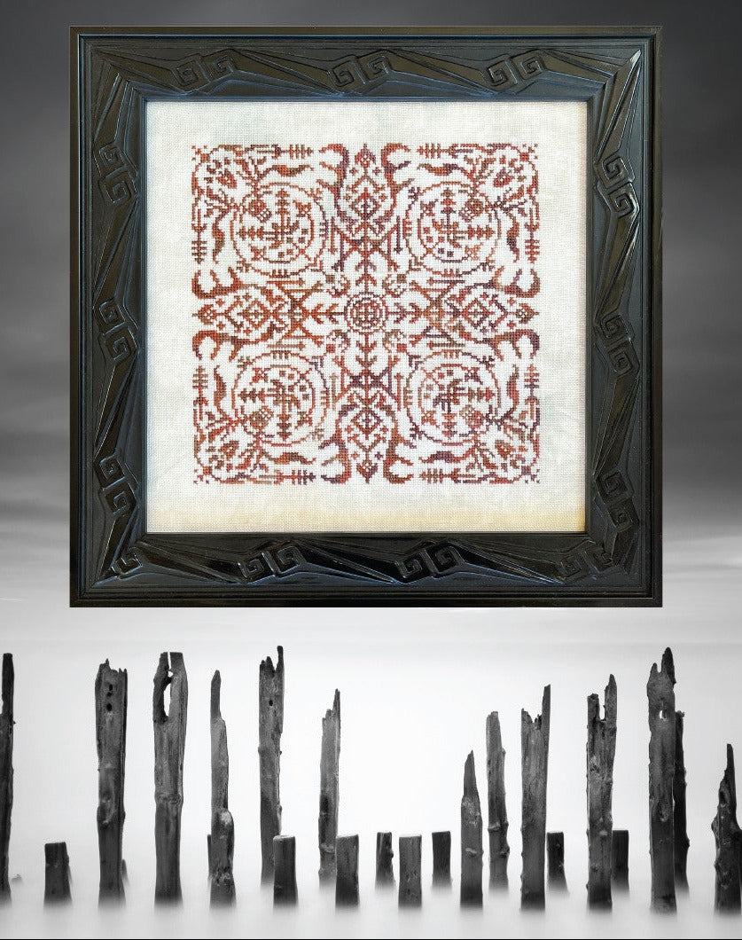 Framed textile with intricate pattern on a dark background