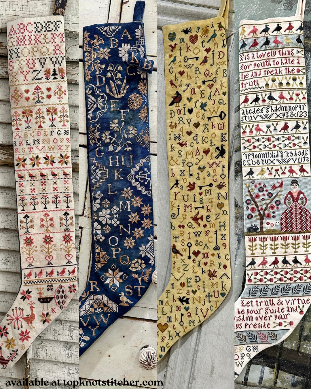 Four vintage-style needlepoint stockings displayed side-by-side on a rustic white wooden wall. Each stocking features a different color scheme and intricate lettering or pattern designs, including a navy blue stocking, a beige stocking with gold lettering, and a white stocking with red and black details.