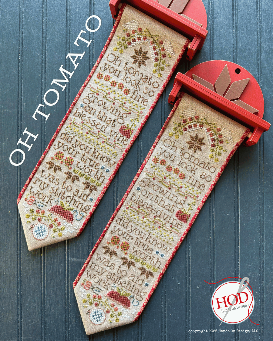 Cross-stitched bookmarks with text and decorative elements on a blue wooden background, featuring the brand 'HOD'.