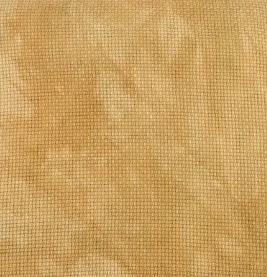 A swatch of hand-dyed fabric with a beige to gold color gradient, textured with a variety of fibers.