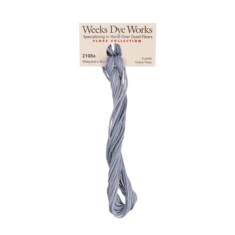 A spool of Weeks Dye Works hand-dyed embroidery floss in the color Shepard's Blue.