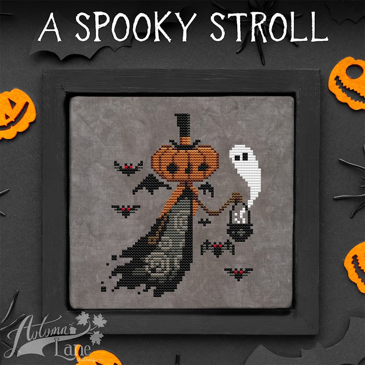 Halloween-themed cross-stitch design with a pumpkin, ghost, and bats on a dark background.