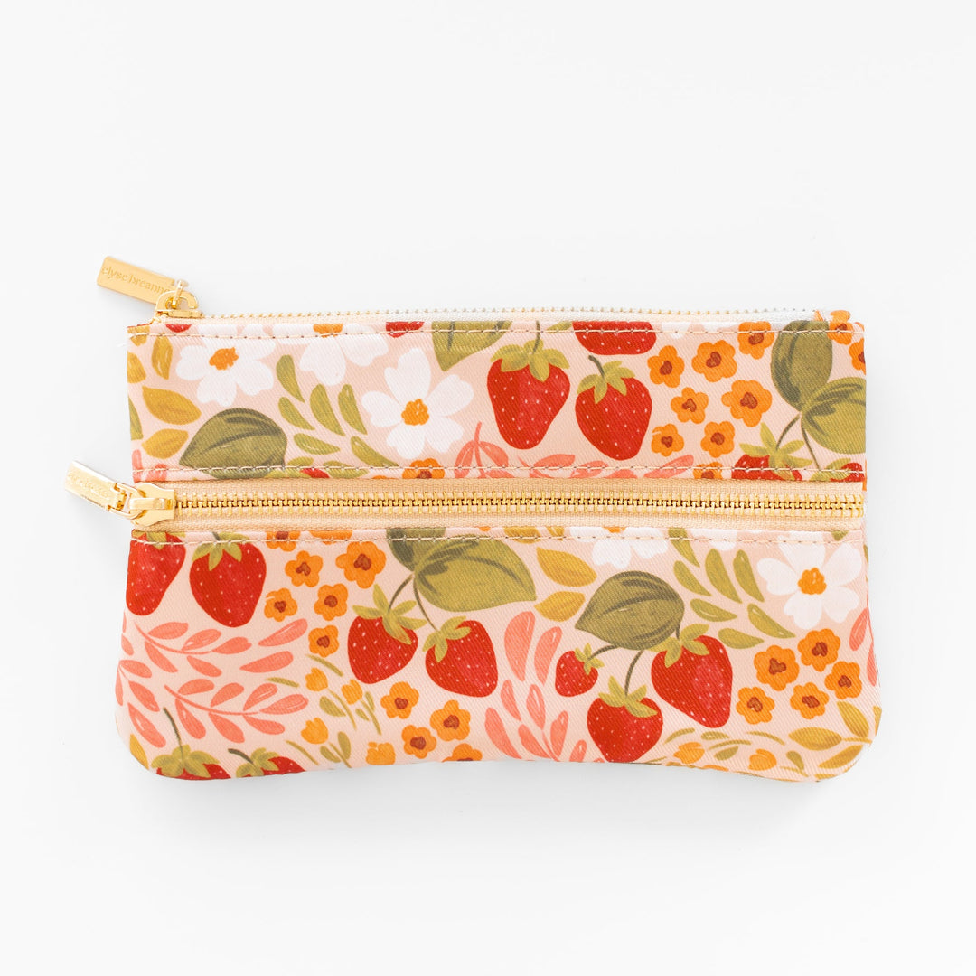 Floral and strawberry patterned pouch with a gold zipper on a white background