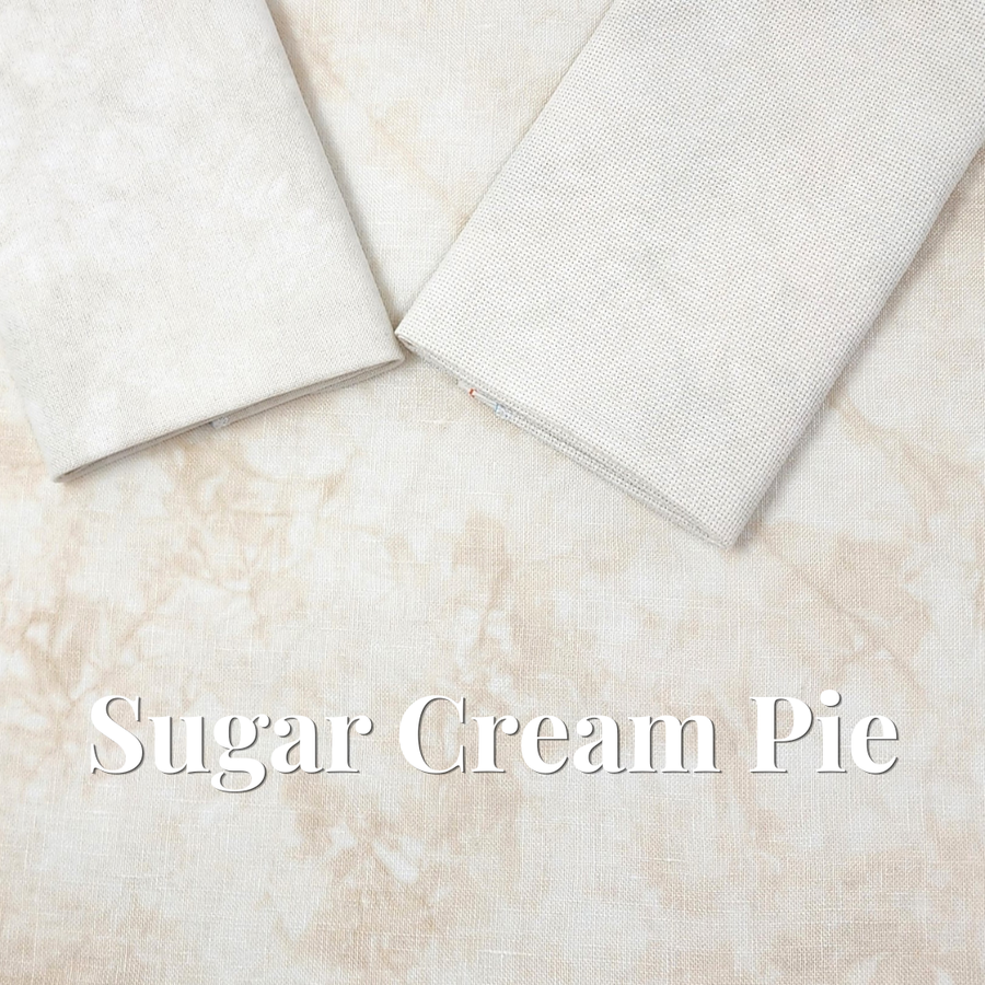 Two folded pieces of textured fabric in a warm cream color, displayed on a matching marbled fabric background with the text 'Sugar Cream Pie' overlaid at the bottom.
