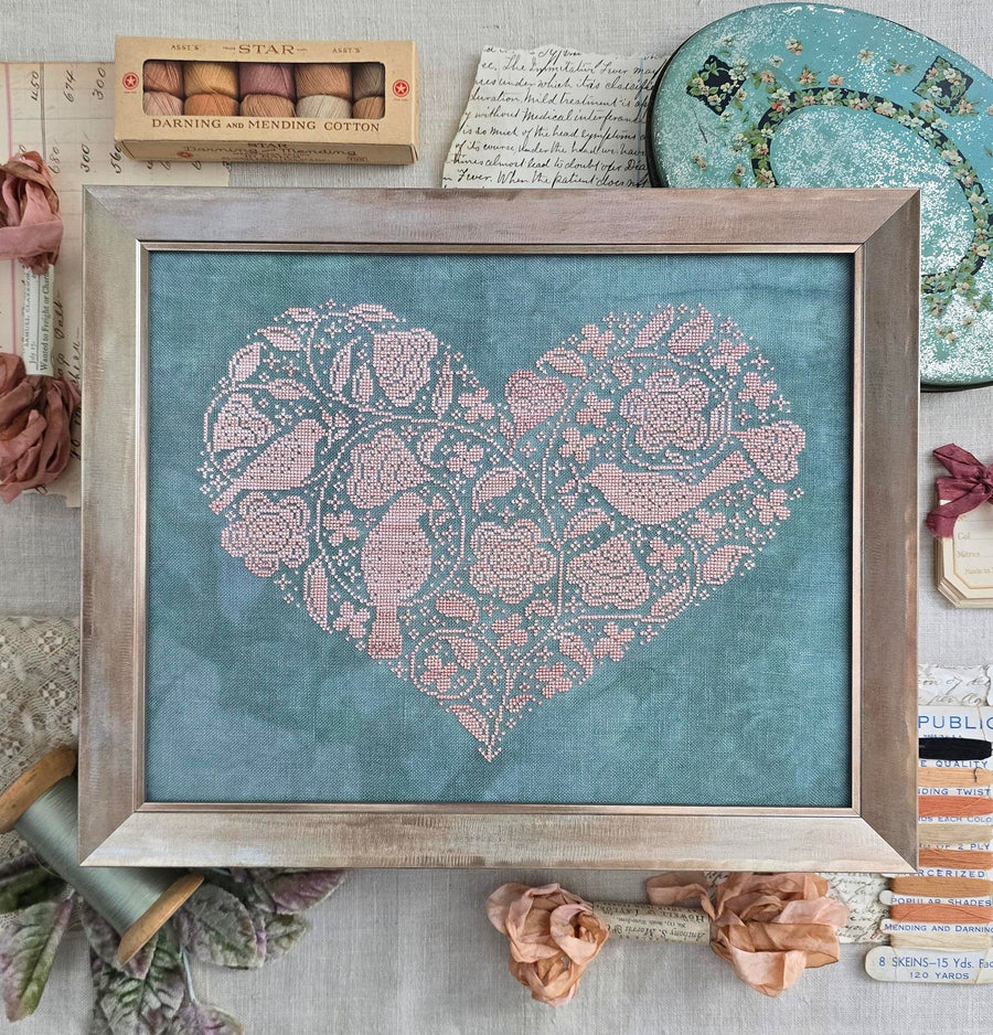 Framed artwork with a heart design on a textured surface