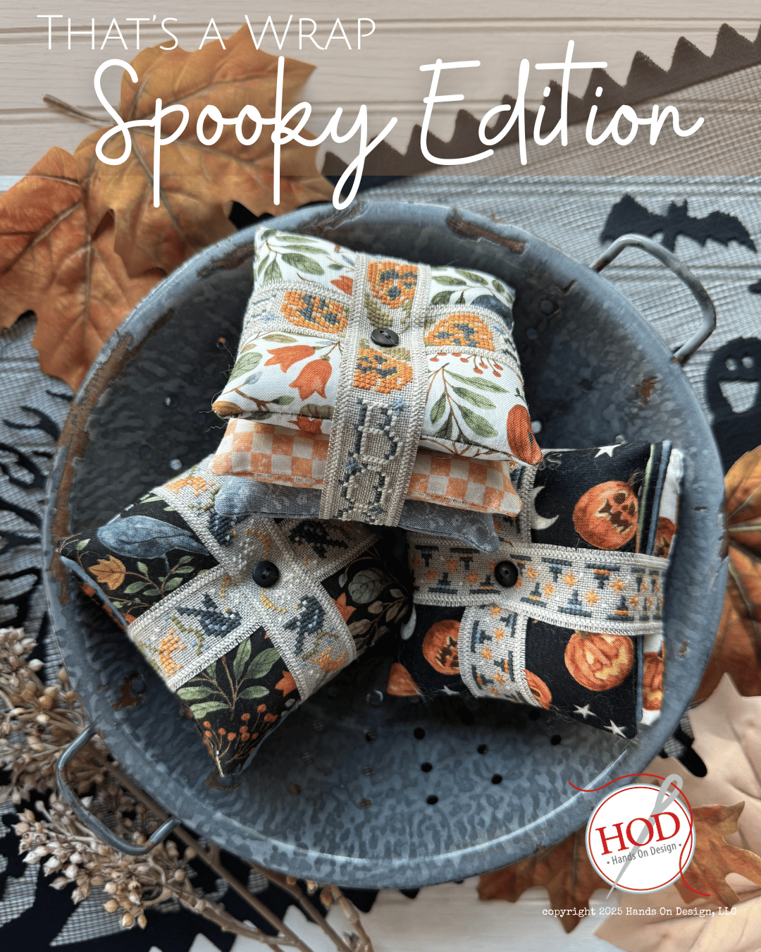 Decorative pillows with Halloween patterns in a metal basket, surrounded by autumn leaves and pumpkins.