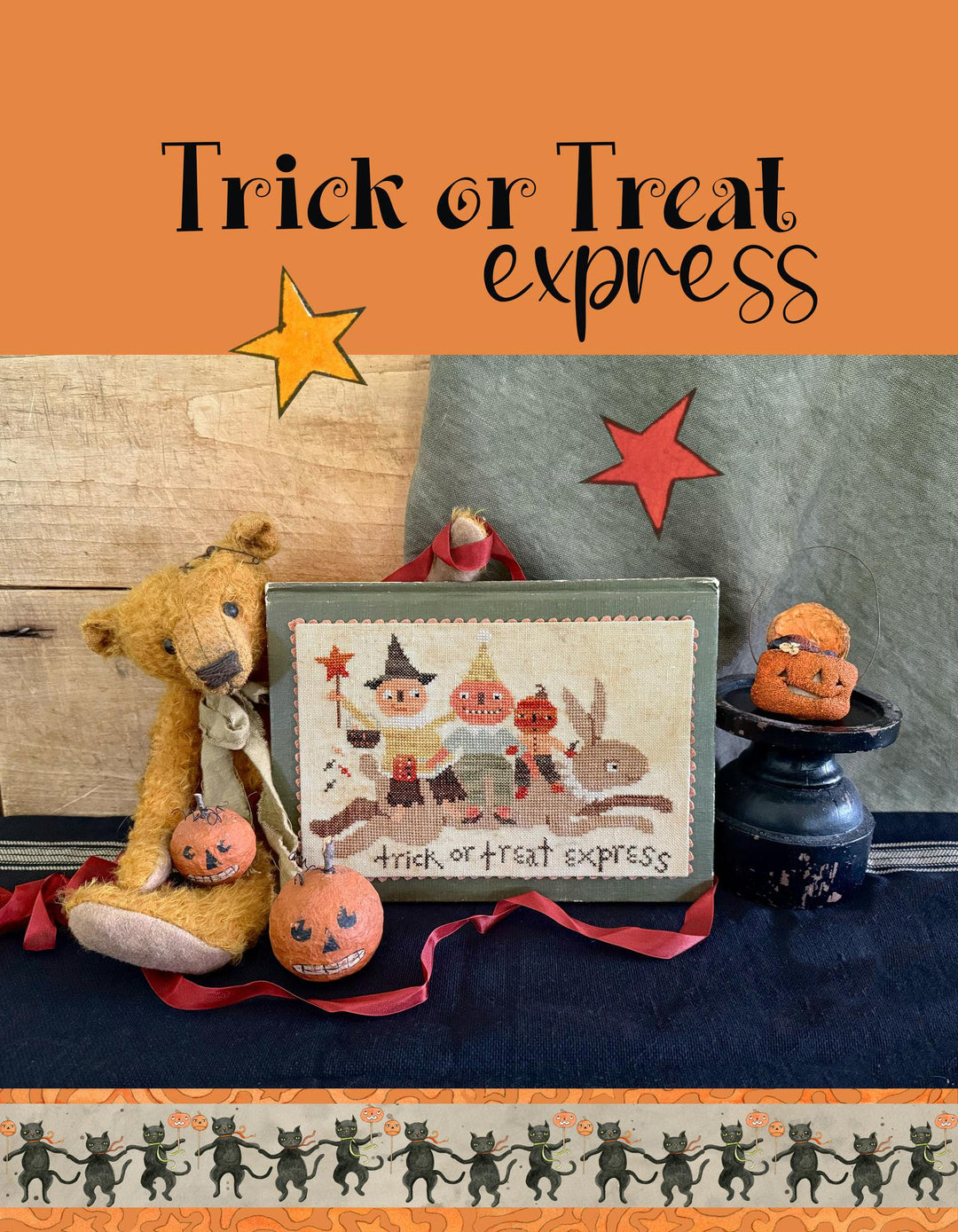 Halloween-themed product with a framed illustration, teddy bear, and pumpkins on an orange background.