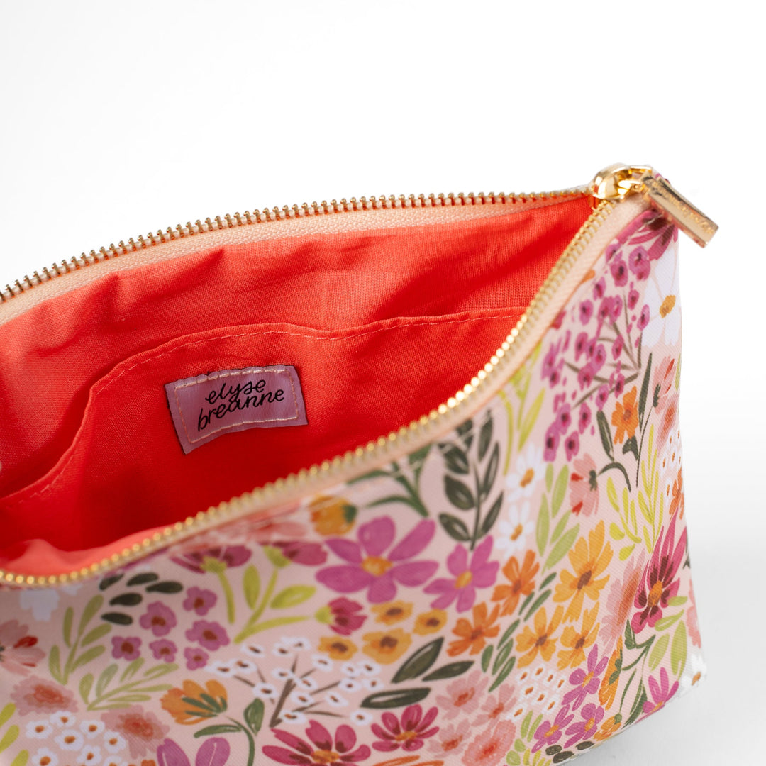 Floral patterned pouch with a visible brand label on a white background