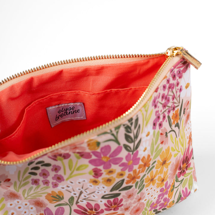 Floral patterned pouch with a visible brand label on a white background