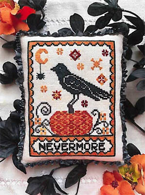 A needlecraft canvas with a design featuring a raven, pumpkin, and floral patterns, labeled 'NEVERMORE'.