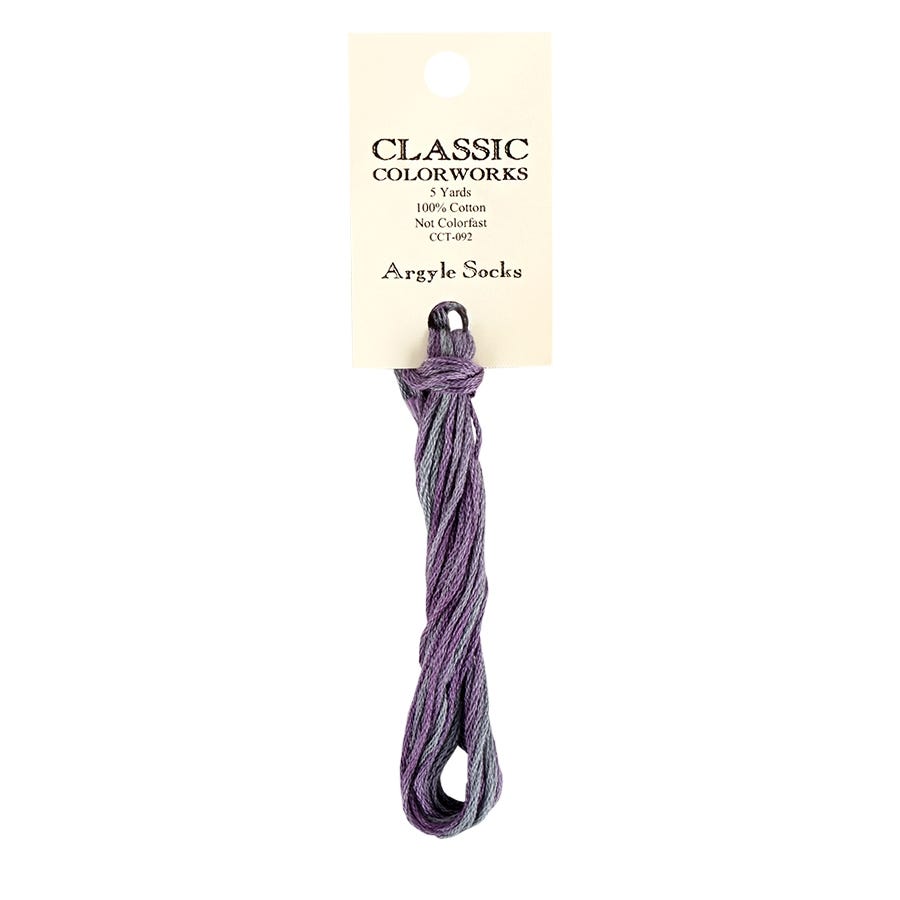 A skein of Classic Colorworks hand-dyed embroidery floss, with a label showing the brand and product name, Argyle Socks.