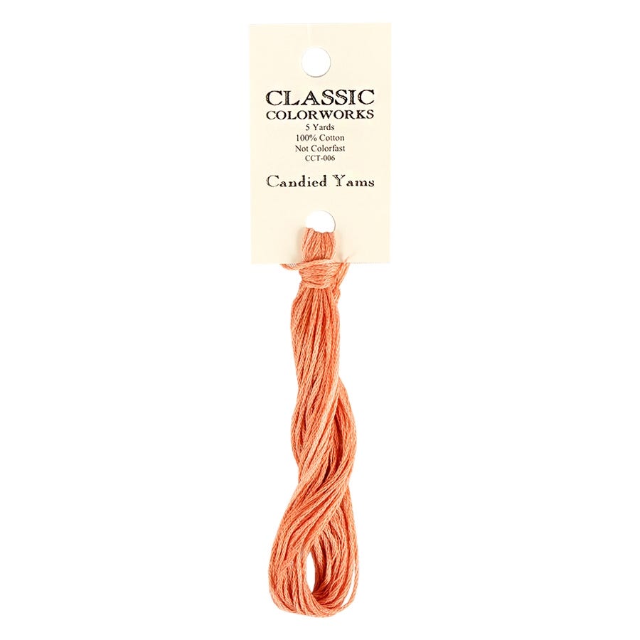 A skein of hand-dyed embroidery floss labeled 'Classic Colorworks' in a solid orange color.