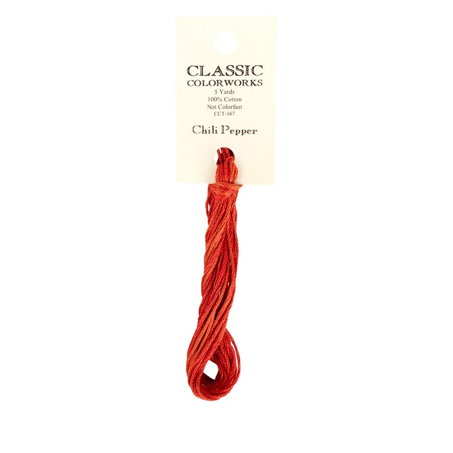 A skein of hand-dyed embroidery floss in red color, labeled 'Chili Pepper' from Classic Colorworks.