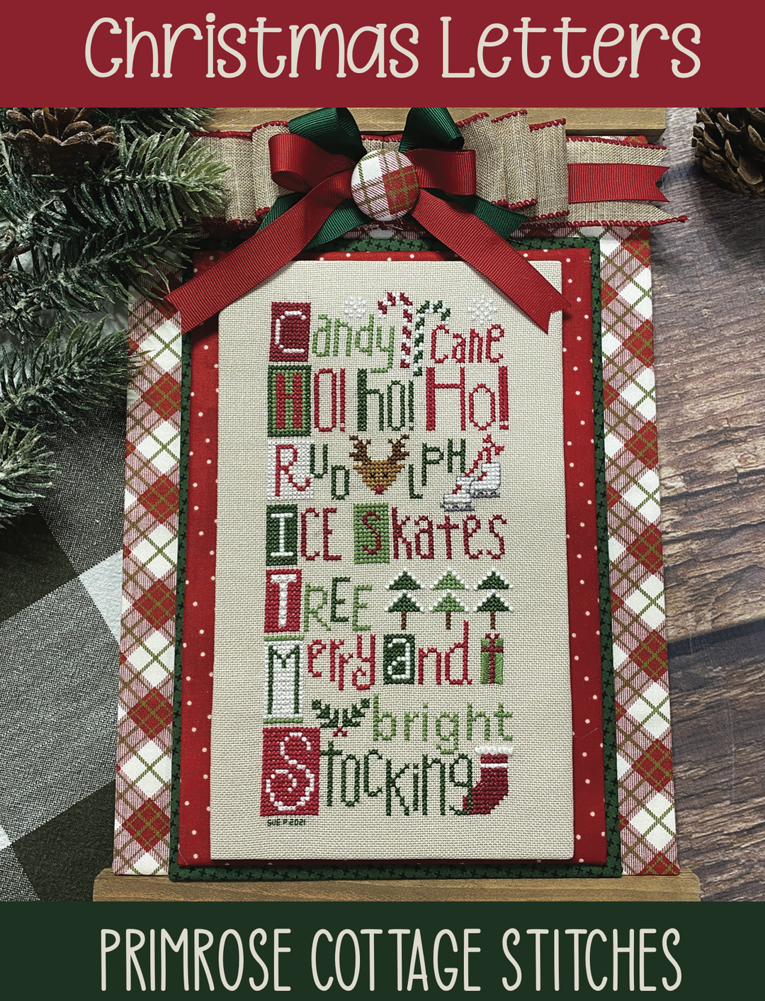 A stitched Christmas letter 'H' from Primrose Cottage Stitches, featuring a red and green plaid pattern with holiday-themed words and decorations.