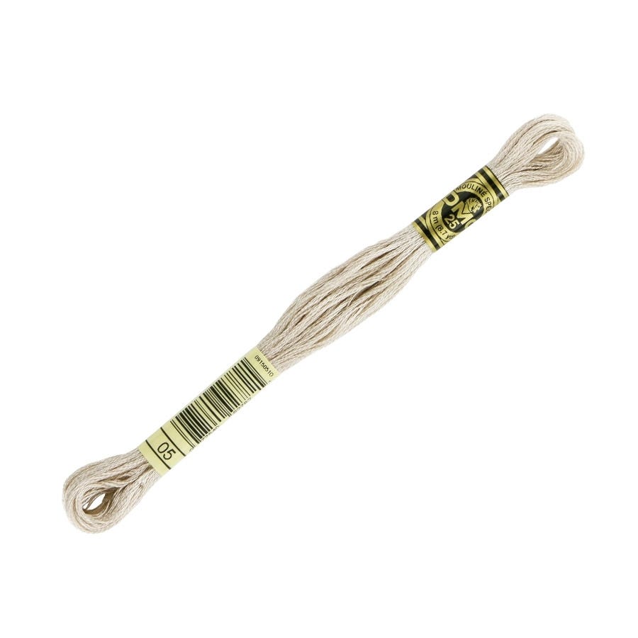 Spool of beige embroidery floss with a label on a white background