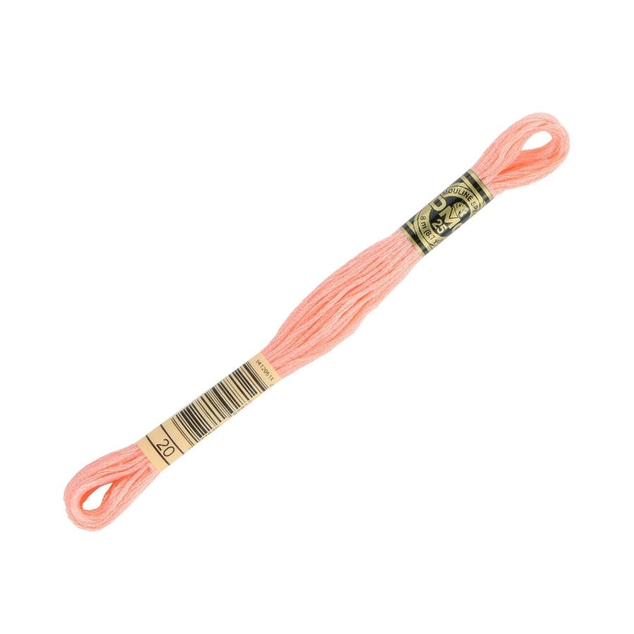 Peach-colored embroidery floss on a white background