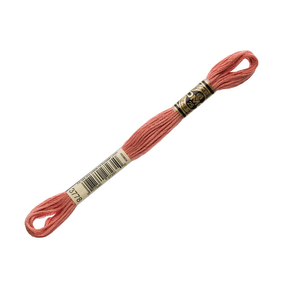 Spool of coral embroidery floss with a brand label on a white background
