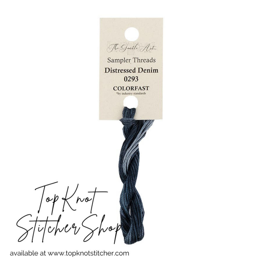 A cardstock display with a small spool of hand-dyed embroidery floss labeled 'Distressed Denim', indicating the color and brand, The Gentle Art.