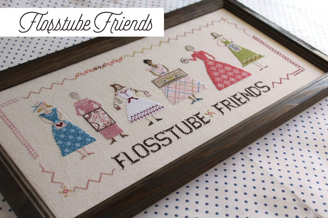 Framed cross-stitched artwork with 'FlossTube Friends' text on a polka dot fabric background.