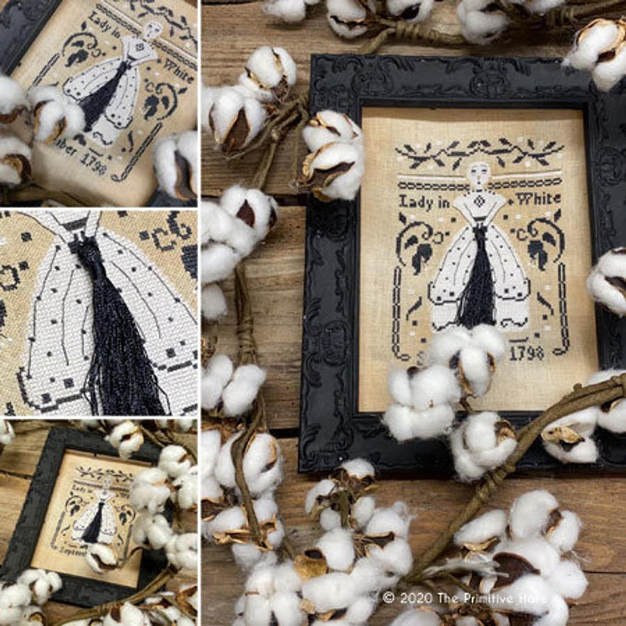 Decorative framed artwork with 'Lady in White' design surrounded by cotton branches.
