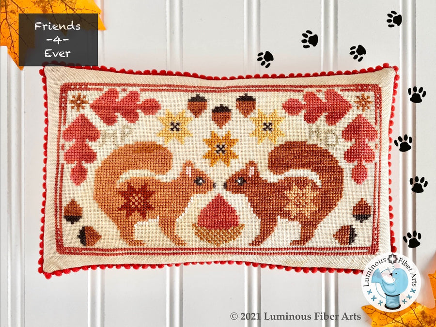 Decorative pillow with autumn-themed design featuring squirrels and leaves on a white background.