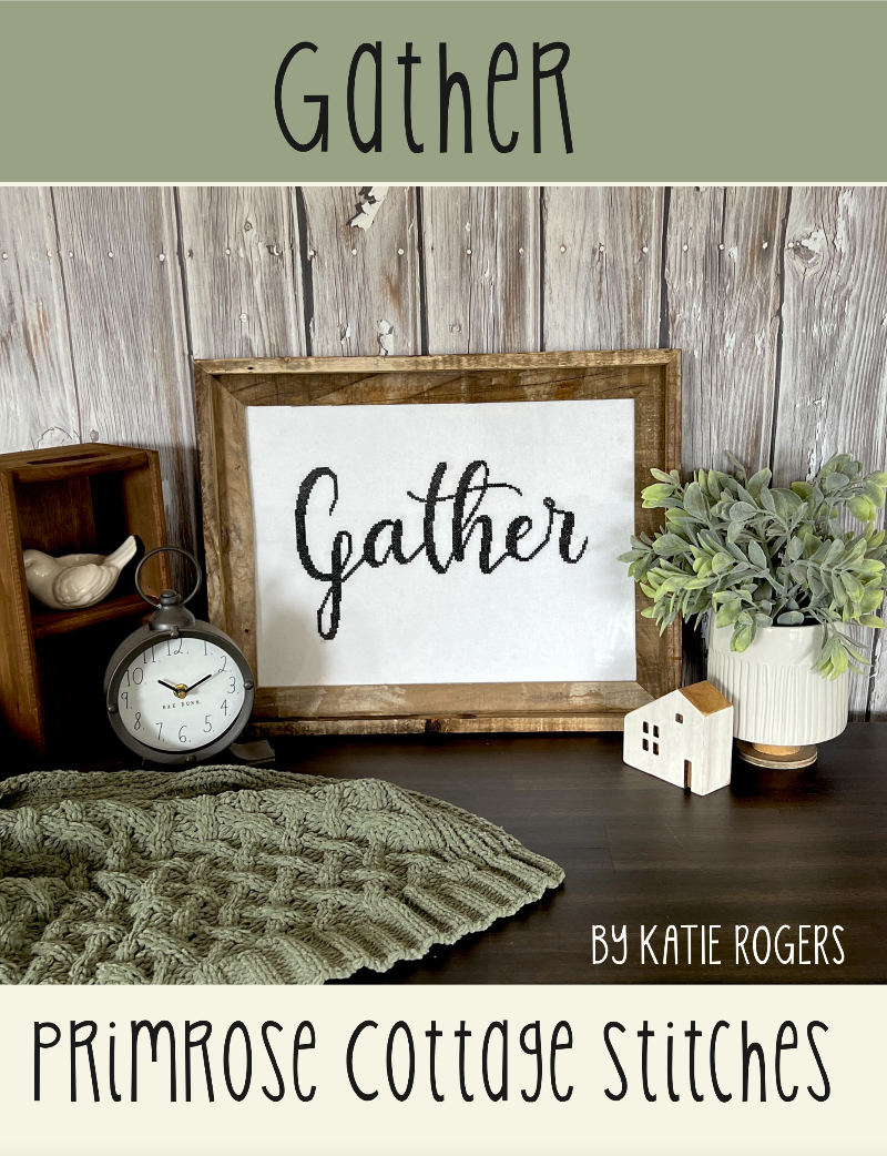 Decorative sign with 'Gather' text in a rustic setting with a clock, plants, and knitted blanket.