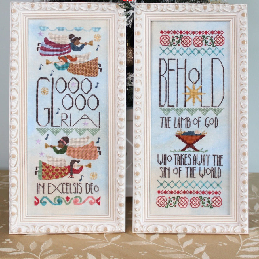 Two framed cross-stitch patterns with decorative borders on a neutral background.