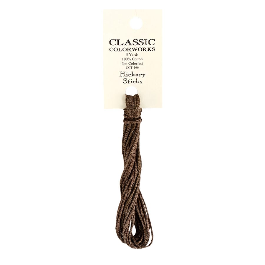 A skein of Classic Colorworks hand-dyed embroidery floss in a brown color, labeled Hickory Sticks.