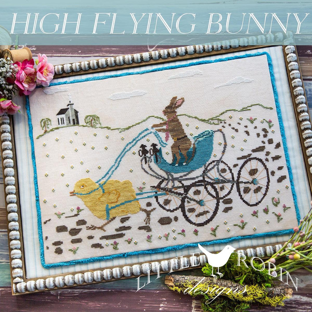 Embroidery of a rabbit in a blue carriage with a duck, framed with decorative elements.
