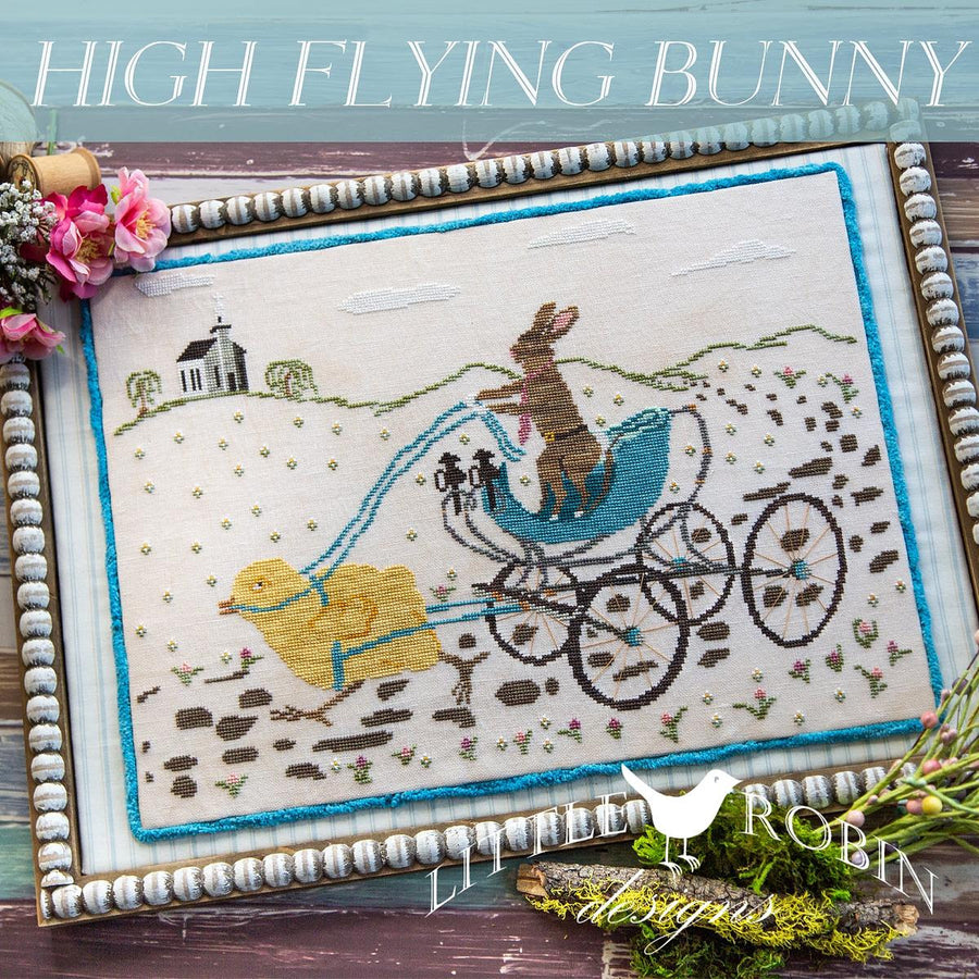 Embroidery of a rabbit in a blue carriage with a duck, framed with decorative elements.