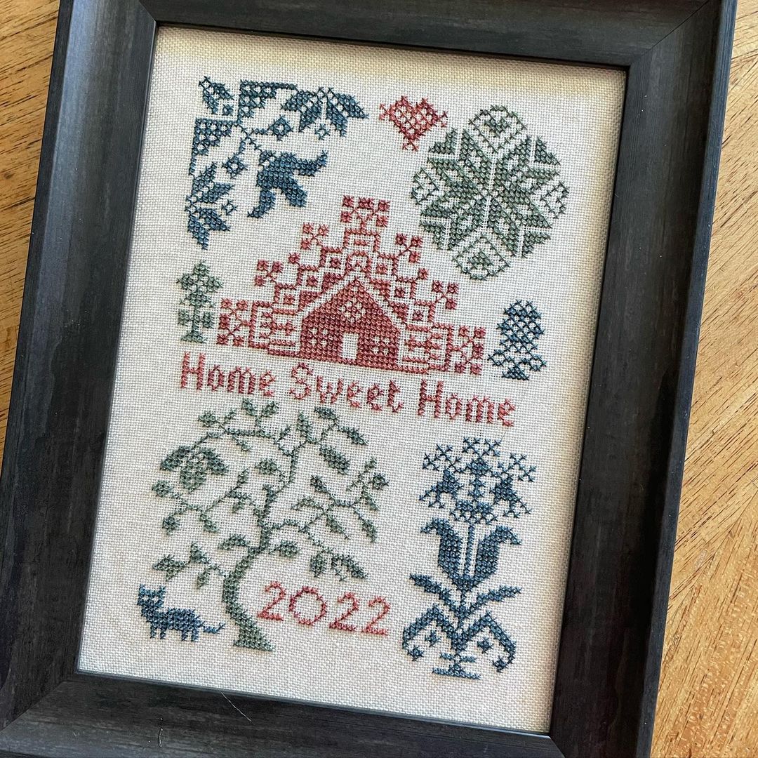 quaker motifs in blue and green with red text readign home sweet home 