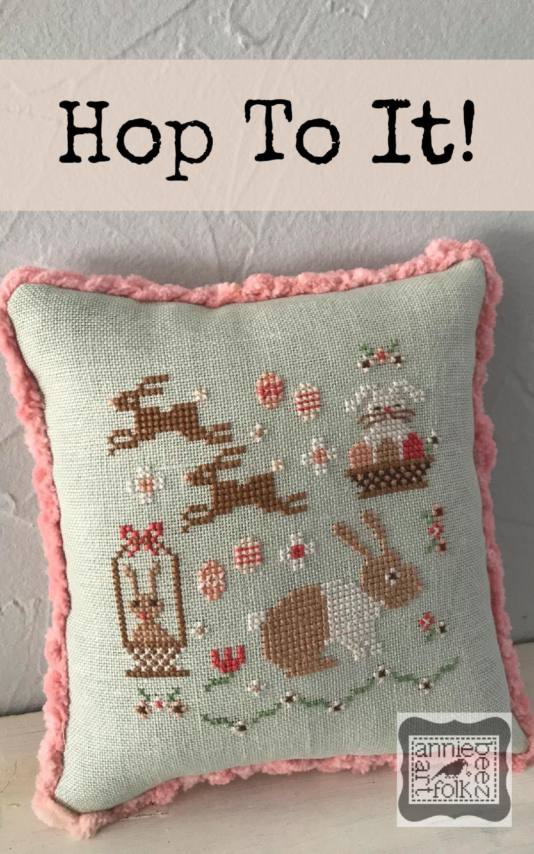 pillow with bunniesa nd pink flowers and esaster eggs trimmed with pink chenille 