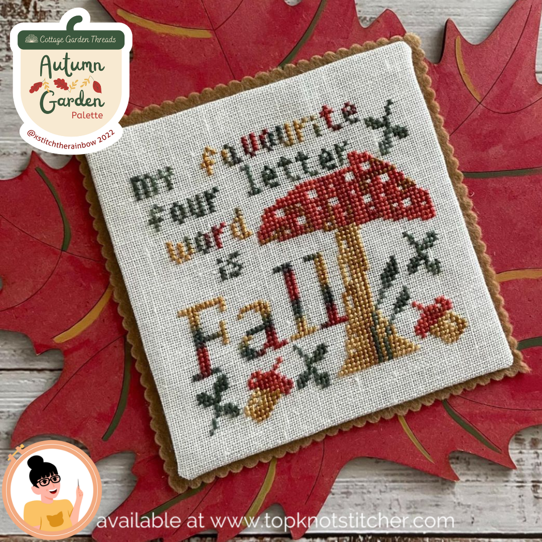 Cross-stitched piece with 'my favourite four letter word is Fall' text on a red leaf background.
