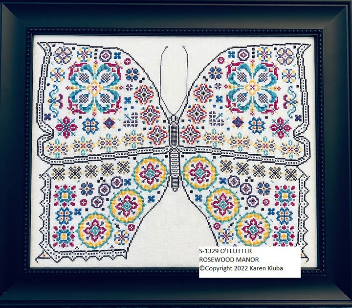 Decorative butterfly design with colorful patterns on a white background, framed in dark blue.