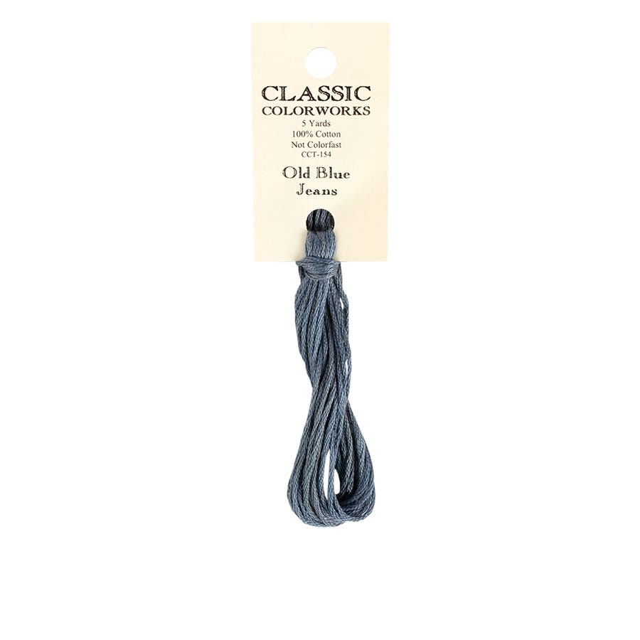 A skein of hand-dyed embroidery floss in a blue color, labeled 'Classic Colorworks Old Blue Jeans' on a white background.