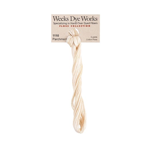 A skein of Weeks Dye Works hand-dyed embroidery floss in a beige color, labeled 'Parchment' and numbered 1110.