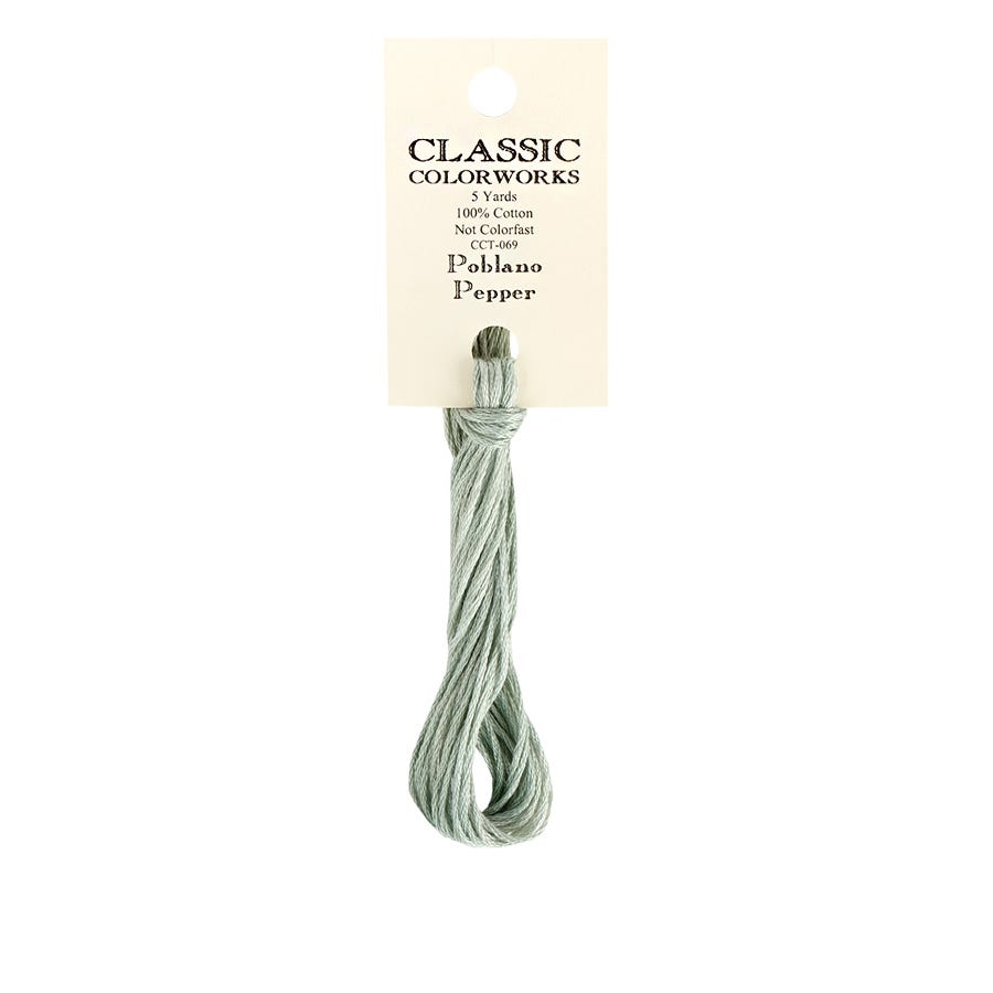 A skein of Classic Colorworks hand-dyed embroidery floss in a green color, labeled 'Poblano Pepper'.