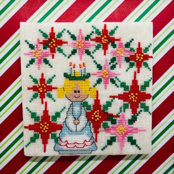Embroidered picture of a girl with flowers on a red and green striped background