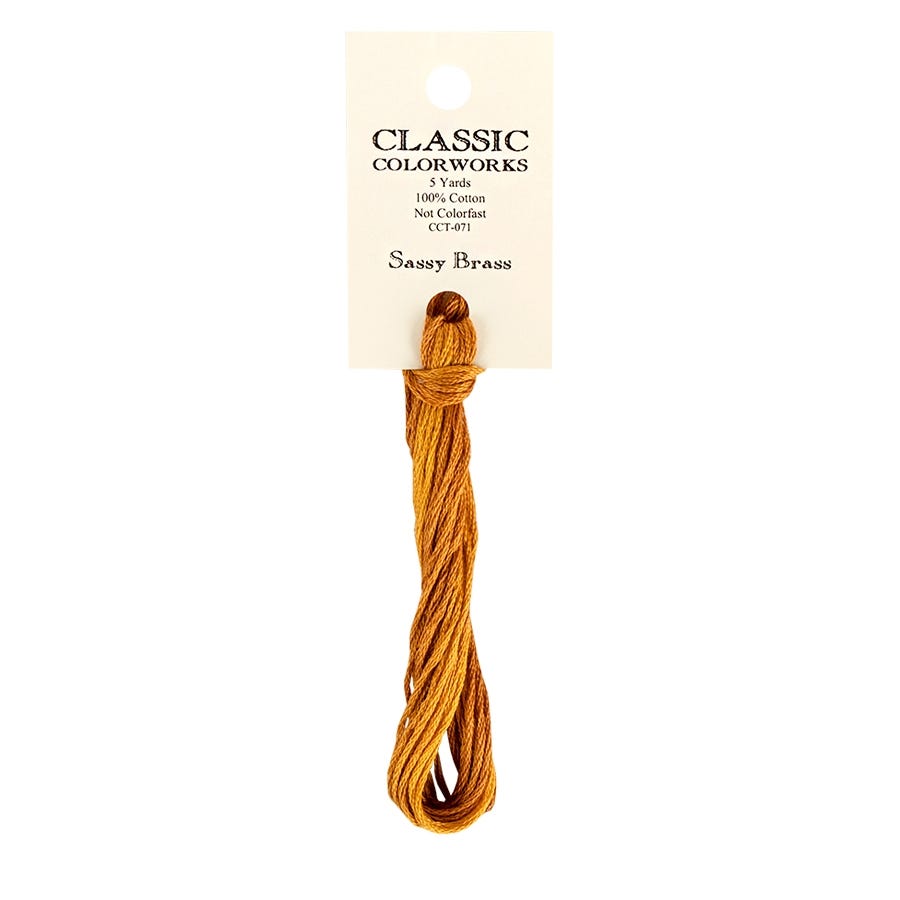 A skein of hand-dyed embroidery floss labeled 'Sassy Brass' by Classic Colorworks, displayed on a card.