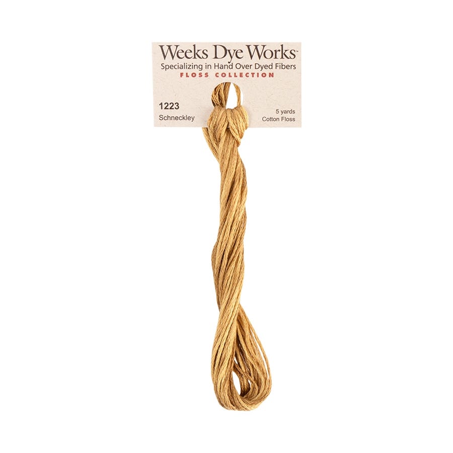 Weeks Dye Works floss collection with a skein of gold thread on a white background