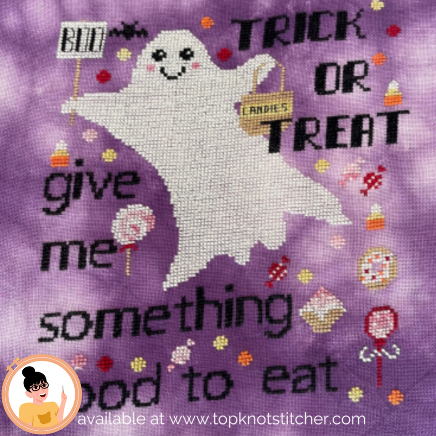 Cross-stitched ghost with Halloween text and candy-themed decorations on a purple background