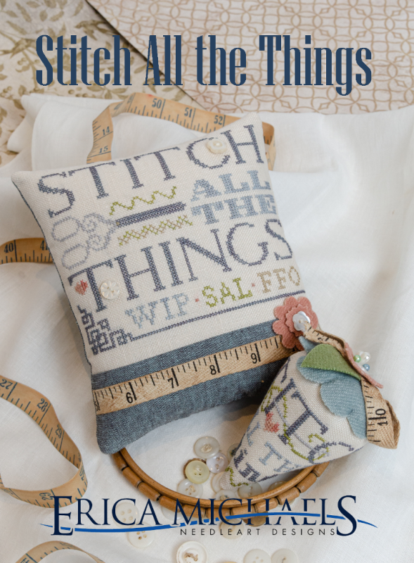 Decorative pillow with cross-stitch design and embroidery hoop on a textured surface