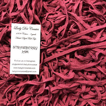 pile of twill tape in a deep pink-red color 